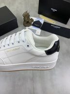 White sneaker side view with black heel panel and Saint Laurent logo.