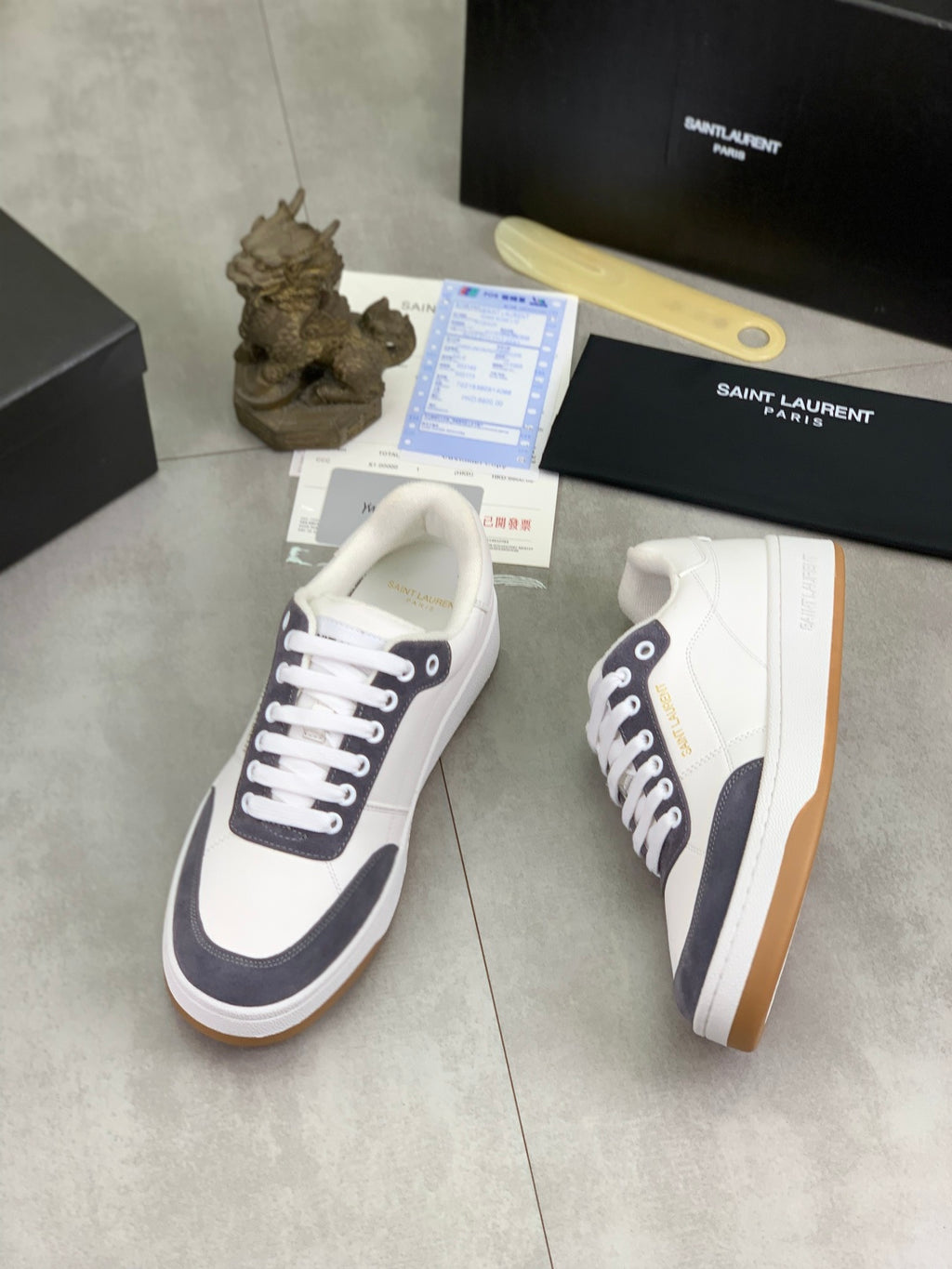 Unisex low-top sneakers, white with navy trim, white laces and gum outsole.