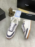 Unisex low-top sneakers, white with navy trim, white laces and gum outsole.