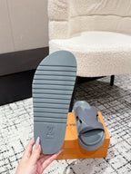Light blue Louis Vuitton slide sandal outsole and footbed with LV logo on orange box