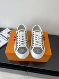Women’s low-top sneakers, dark monogram canvas, white laces and rubber sole.