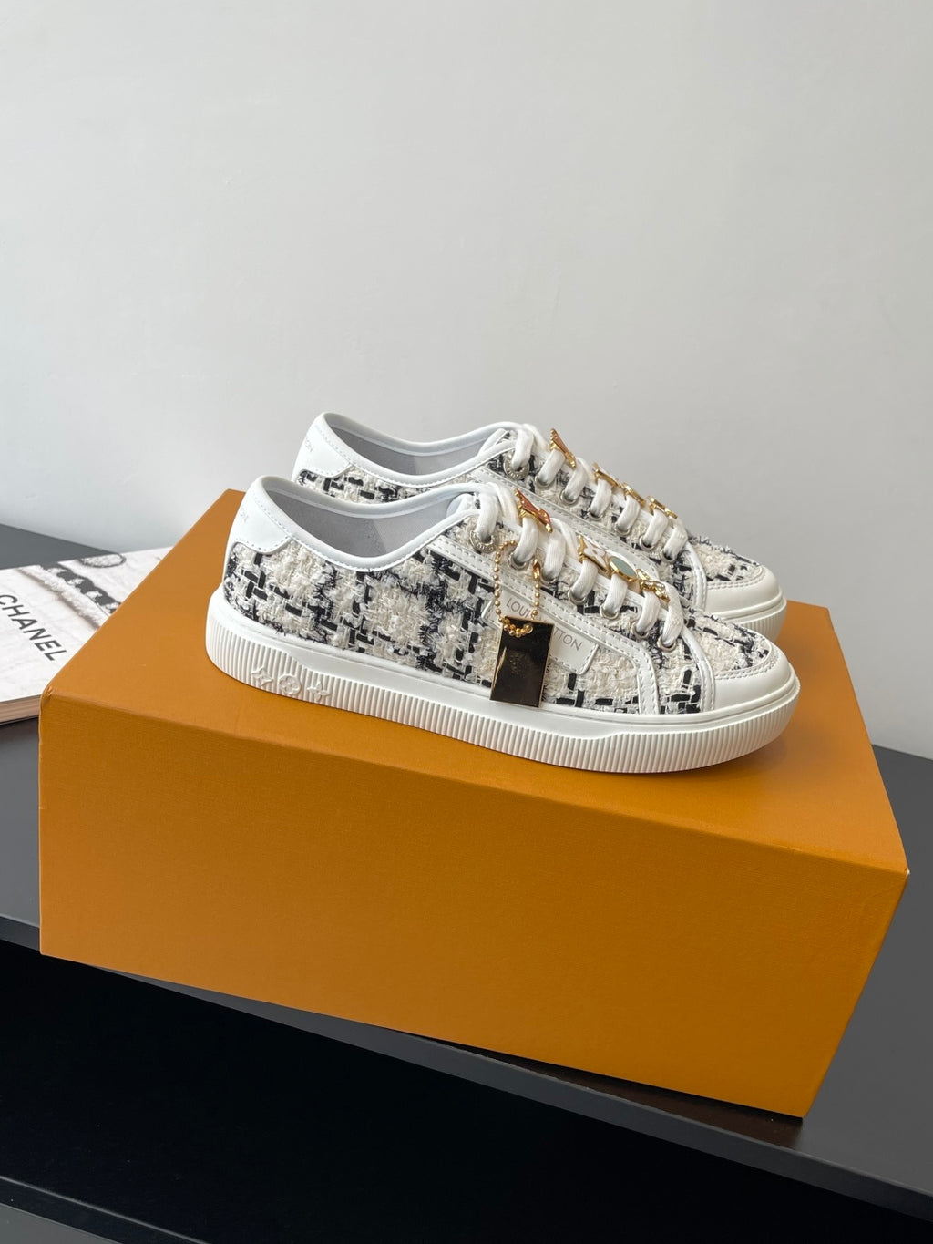 Louis Vuitton women's sneakers, white with black tweed-style pattern, lace-up.