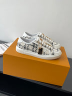 Louis Vuitton women's sneakers, white with black tweed-style pattern, lace-up.