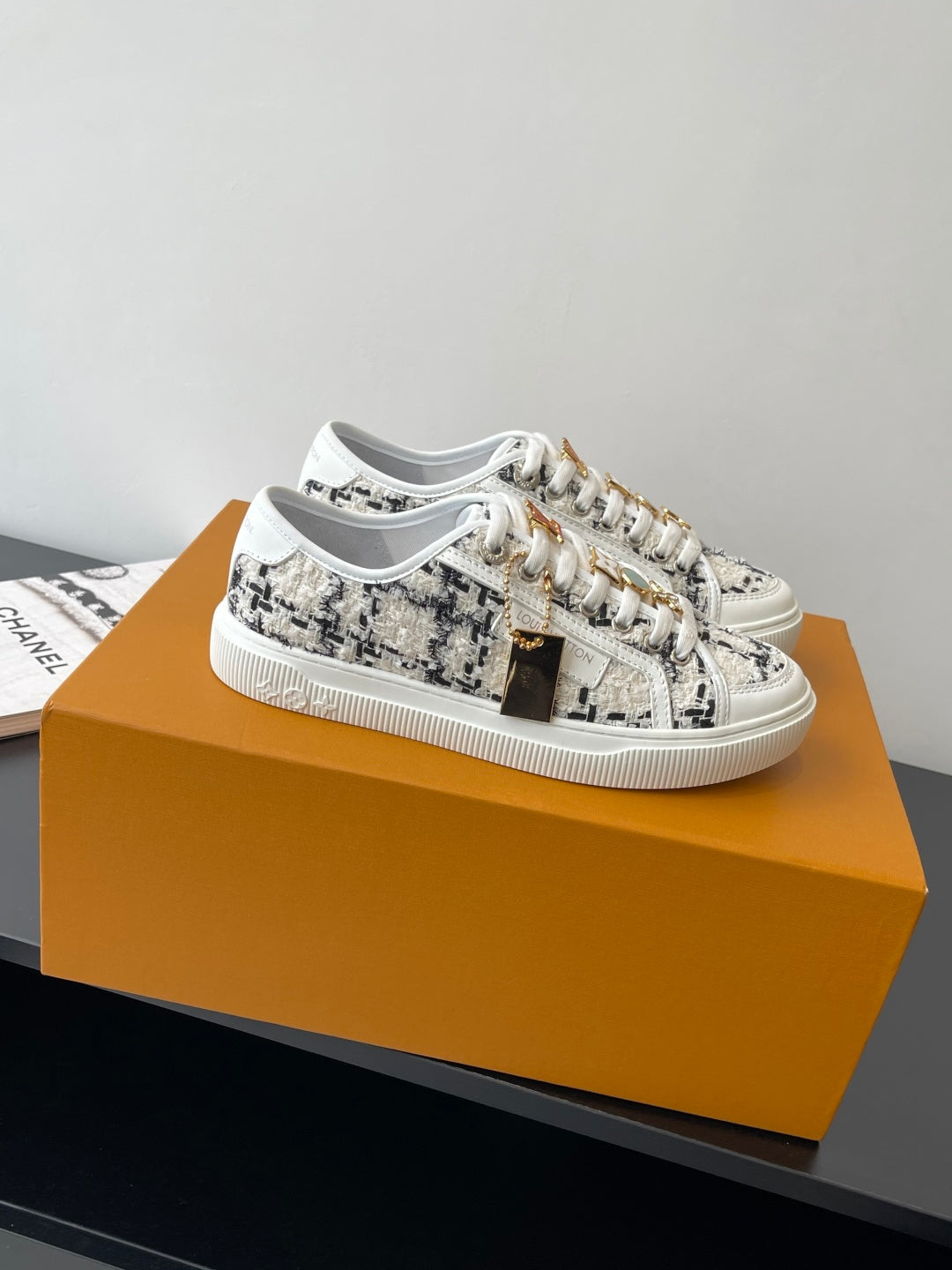 Louis Vuitton women's sneakers, white with black tweed-style pattern, lace-up.