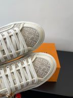 Louis Vuitton ladies sneakers, monogram canvas and white laces close-up