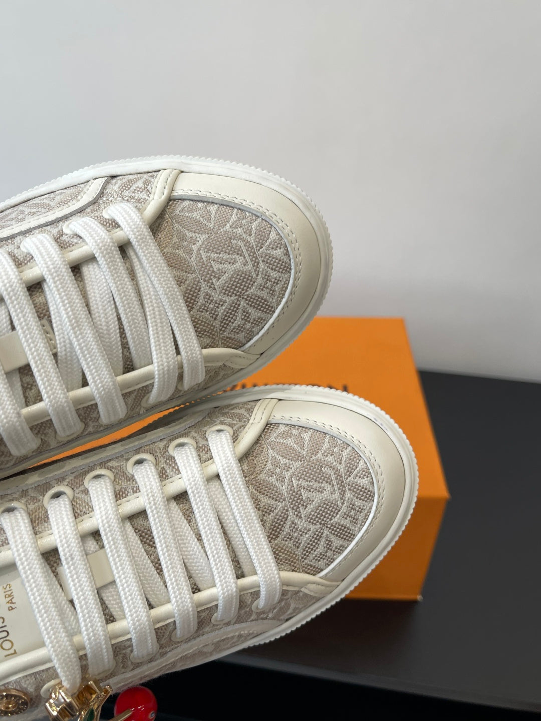 Louis Vuitton ladies sneakers, monogram canvas and white laces close-up
