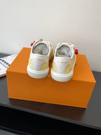 Louis Vuitton low-top sneakers, heel view with white back and pale yellow uppers