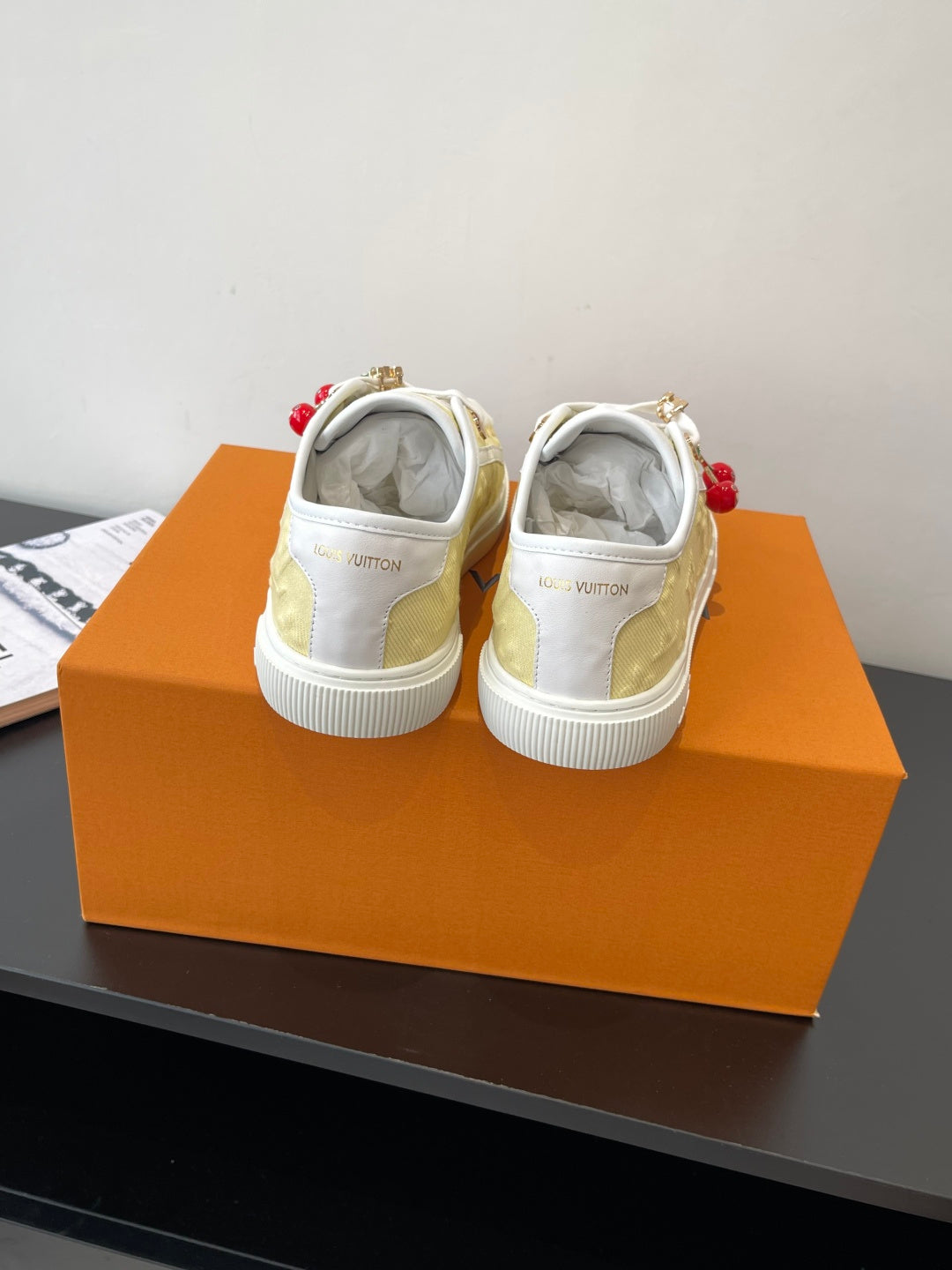Louis Vuitton low-top sneakers, heel view with white back and pale yellow uppers