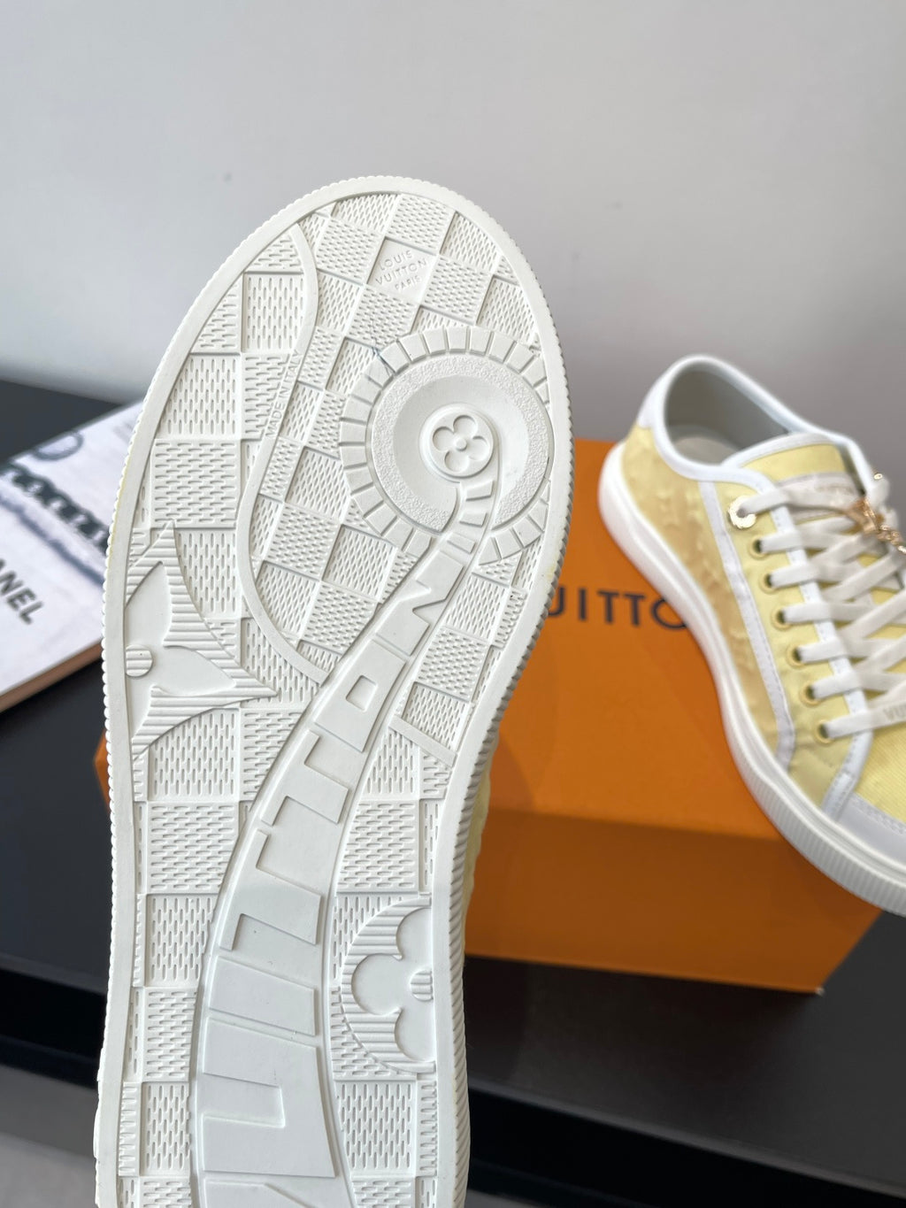 Louis Vuitton sneaker outsole, white tread pattern with circular logo emblem