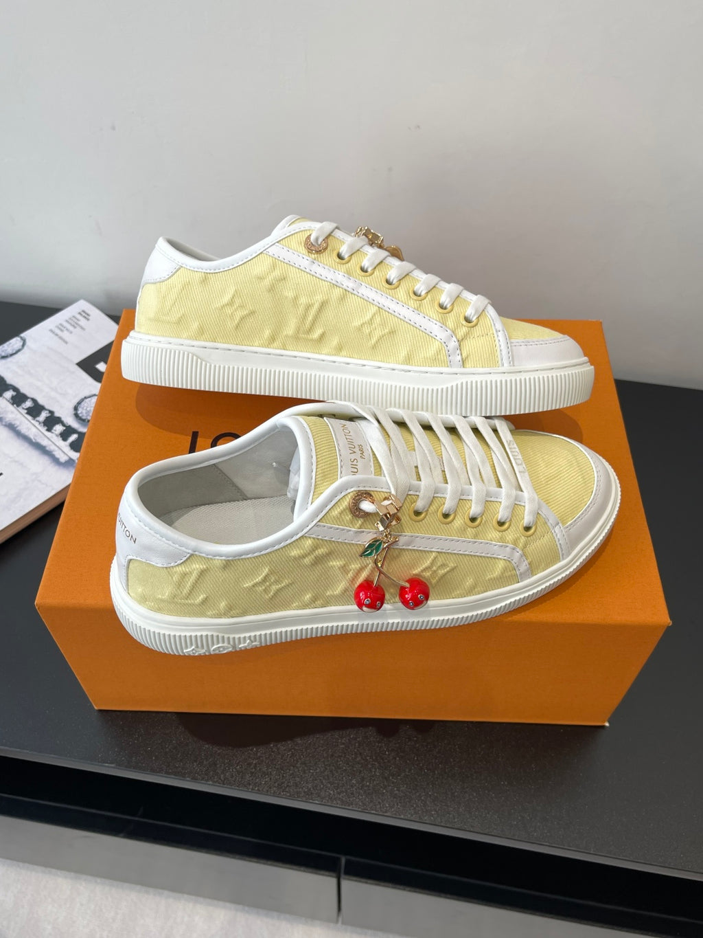 Louis Vuitton low-top sneakers, pair view with white sole and pale yellow uppers