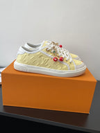 Louis Vuitton low-top sneakers, pale yellow upper with white side stripe and laces