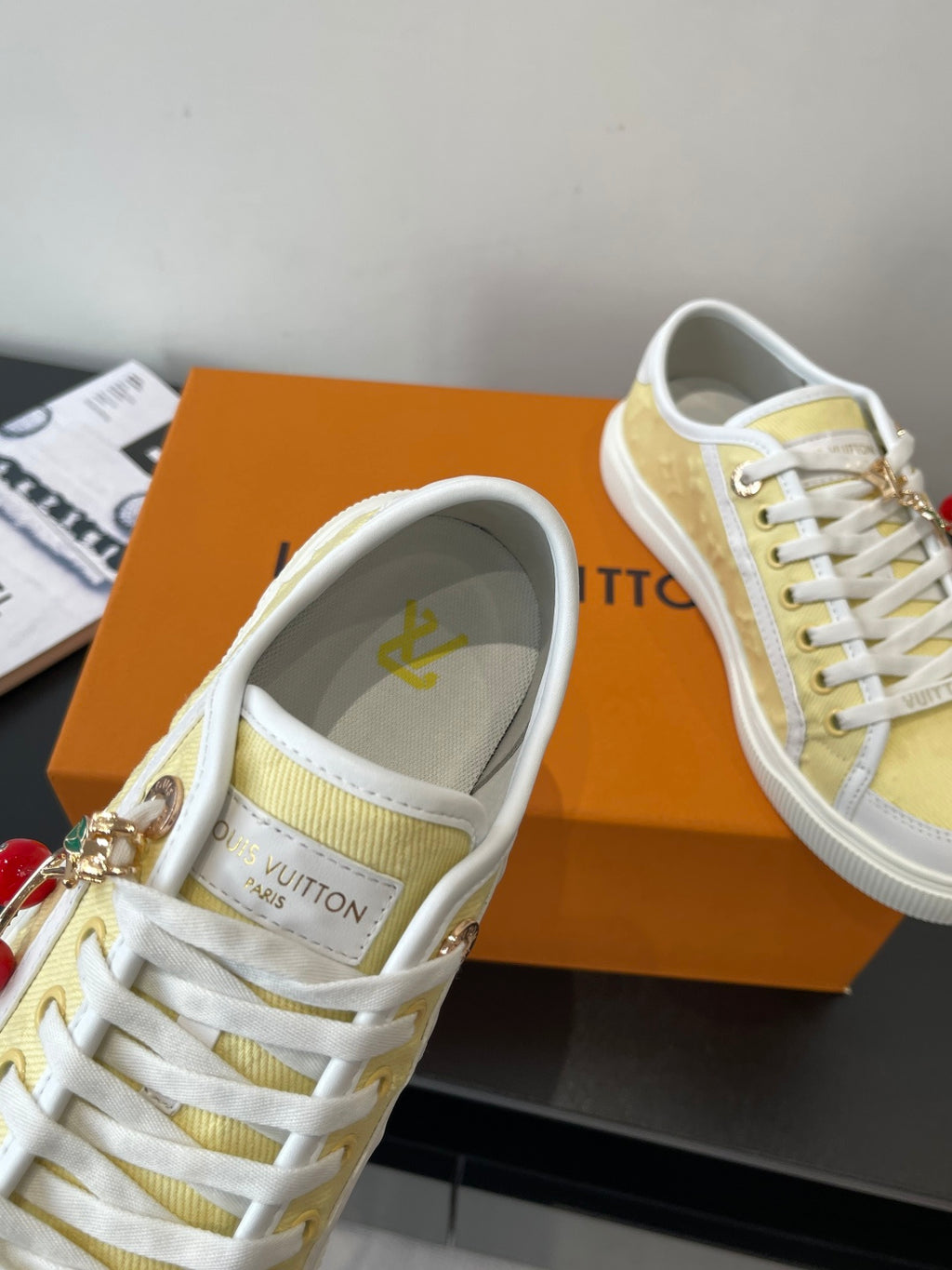 Louis Vuitton low-top sneakers, close view of laces on pale yellow tongue and lining