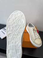Women's Louis Vuitton sneakers, outsole view with textured tread and beige toe cap.