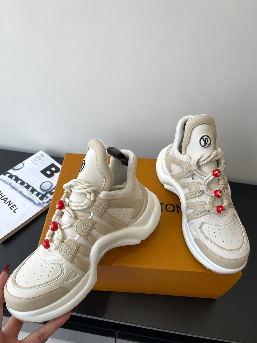 Louis Vuitton women's cream sneakers angled, red bead lace charms, thick sole