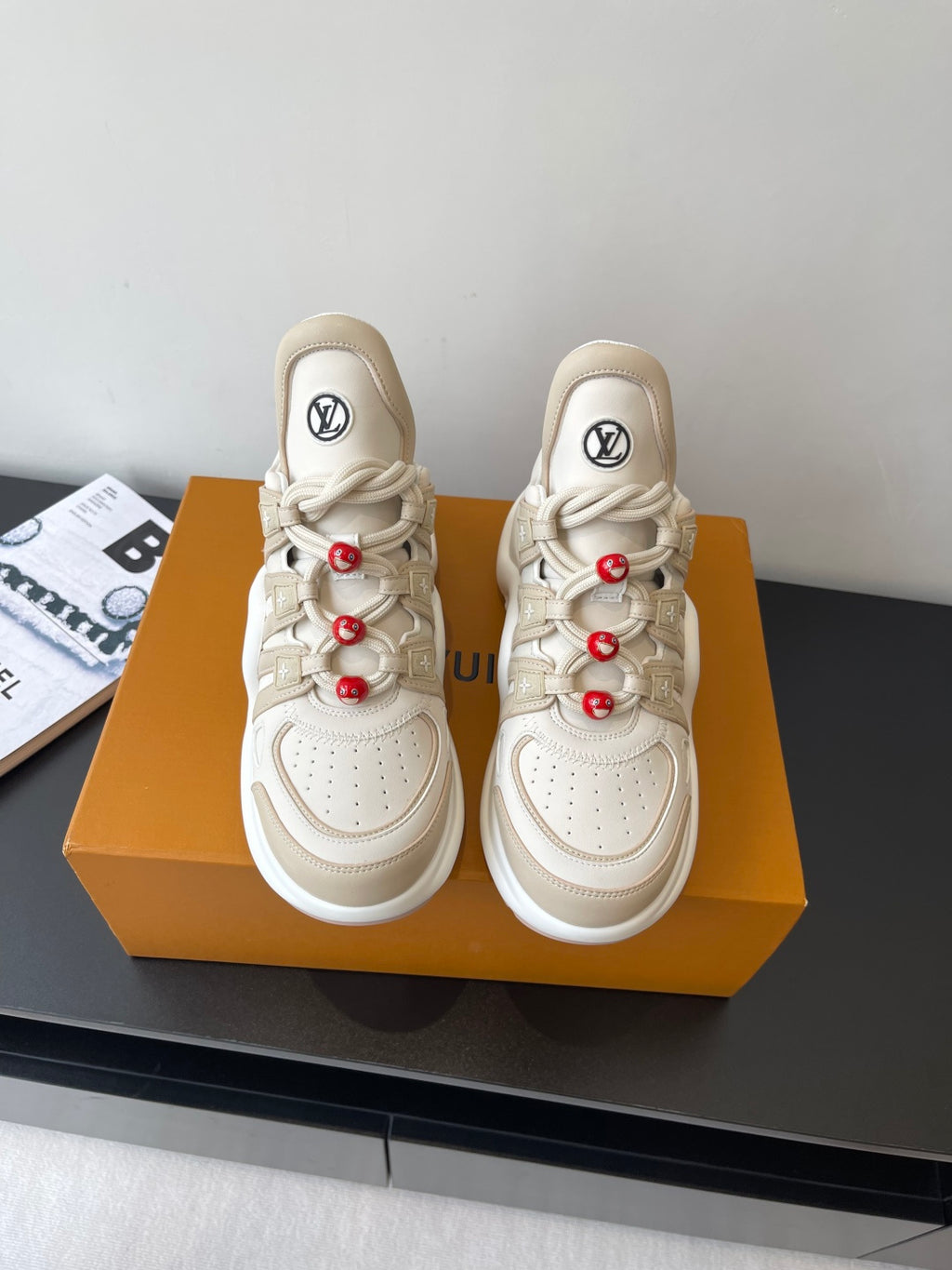Louis Vuitton women's cream sneakers, lace-up with red bead charms and chunky sole