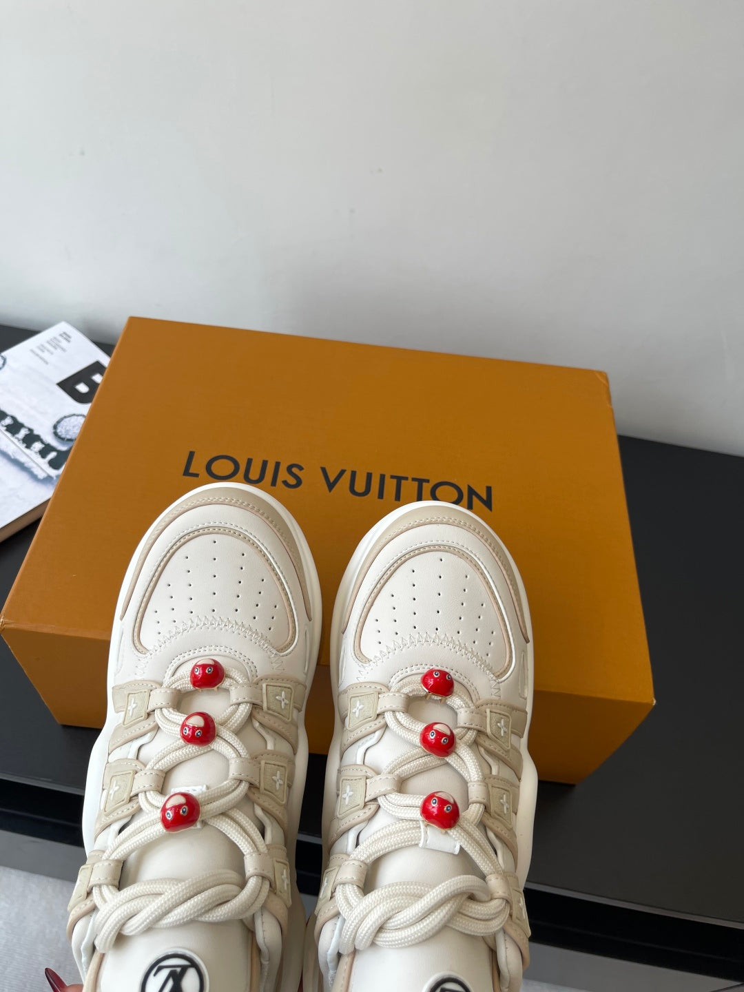 Louis Vuitton women's cream sneakers toe and lace detail, red bead charms