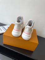 White and pink slip-on sneakers with padded heel and LV logo on back