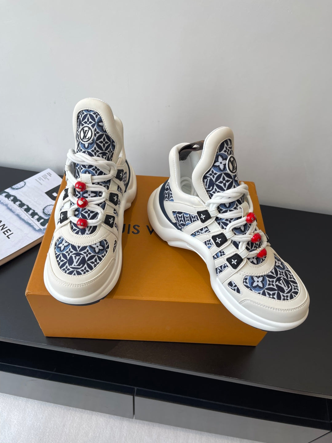 Louis Vuitton women's sneakers side-by-side, white uppers with navy monogram design