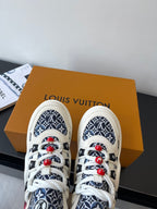 Louis Vuitton women's sneakers pair on box, white uppers with navy patterned panels