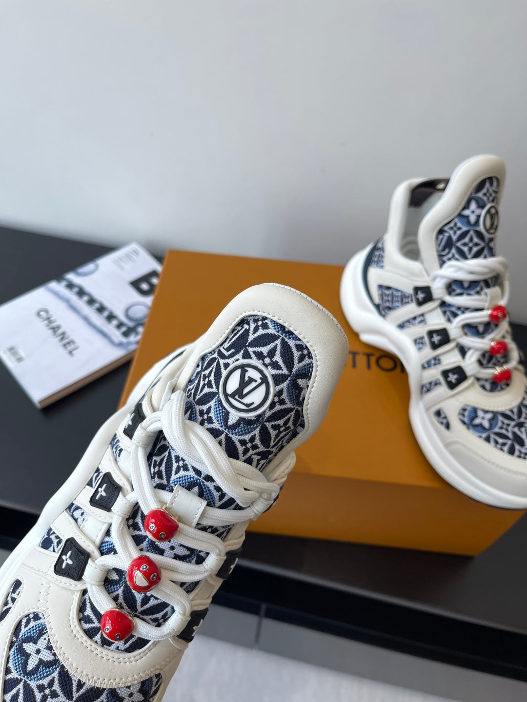Louis Vuitton women's sneakers close-up, white leather with navy monogram panels