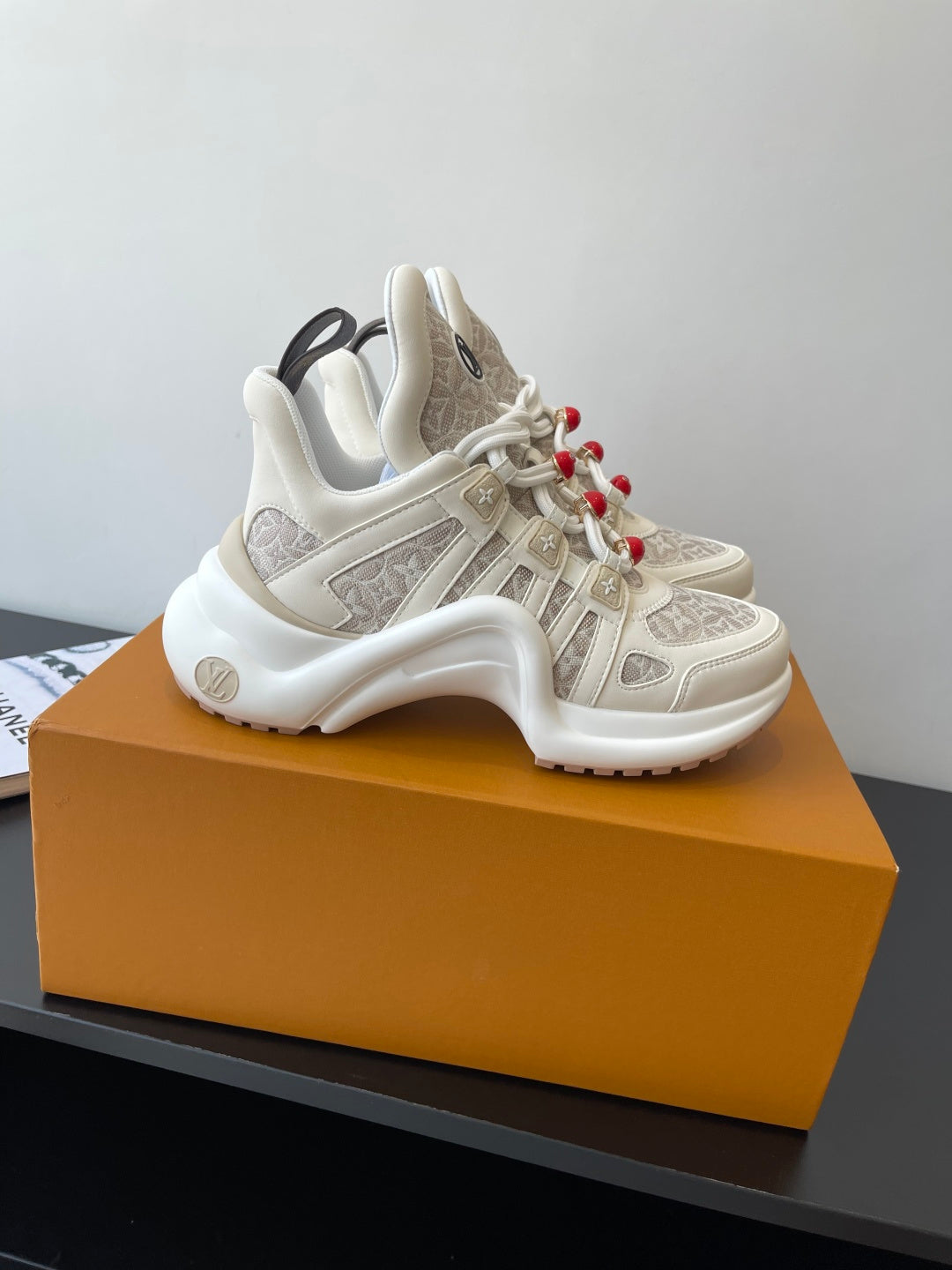 Louis Vuitton chunky low-top sneakers, off-white with beige monogram panels and red laces