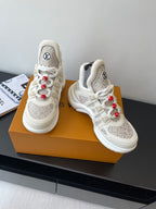 Louis Vuitton low-top sneakers front view, off-white with beige monogram uppers and red laces