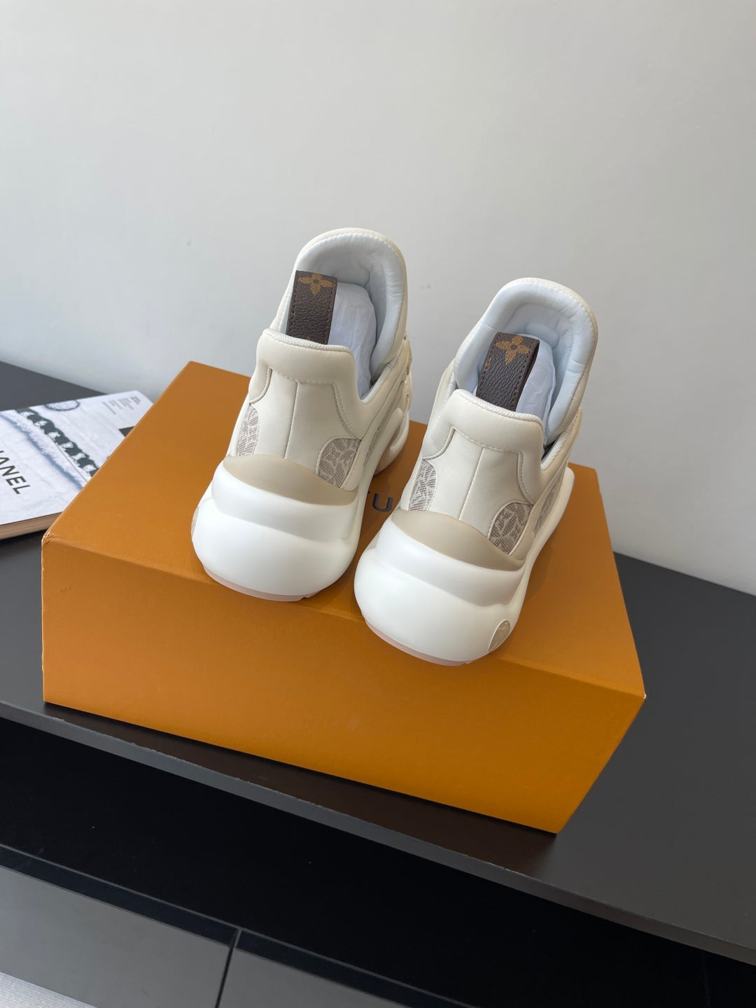 Louis Vuitton sneakers back view, off-white uppers with cushioned heel and beige monogram lining