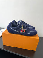 Louis Vuitton ladies navy sneakers, side view with lace-up and charm detail on tongue