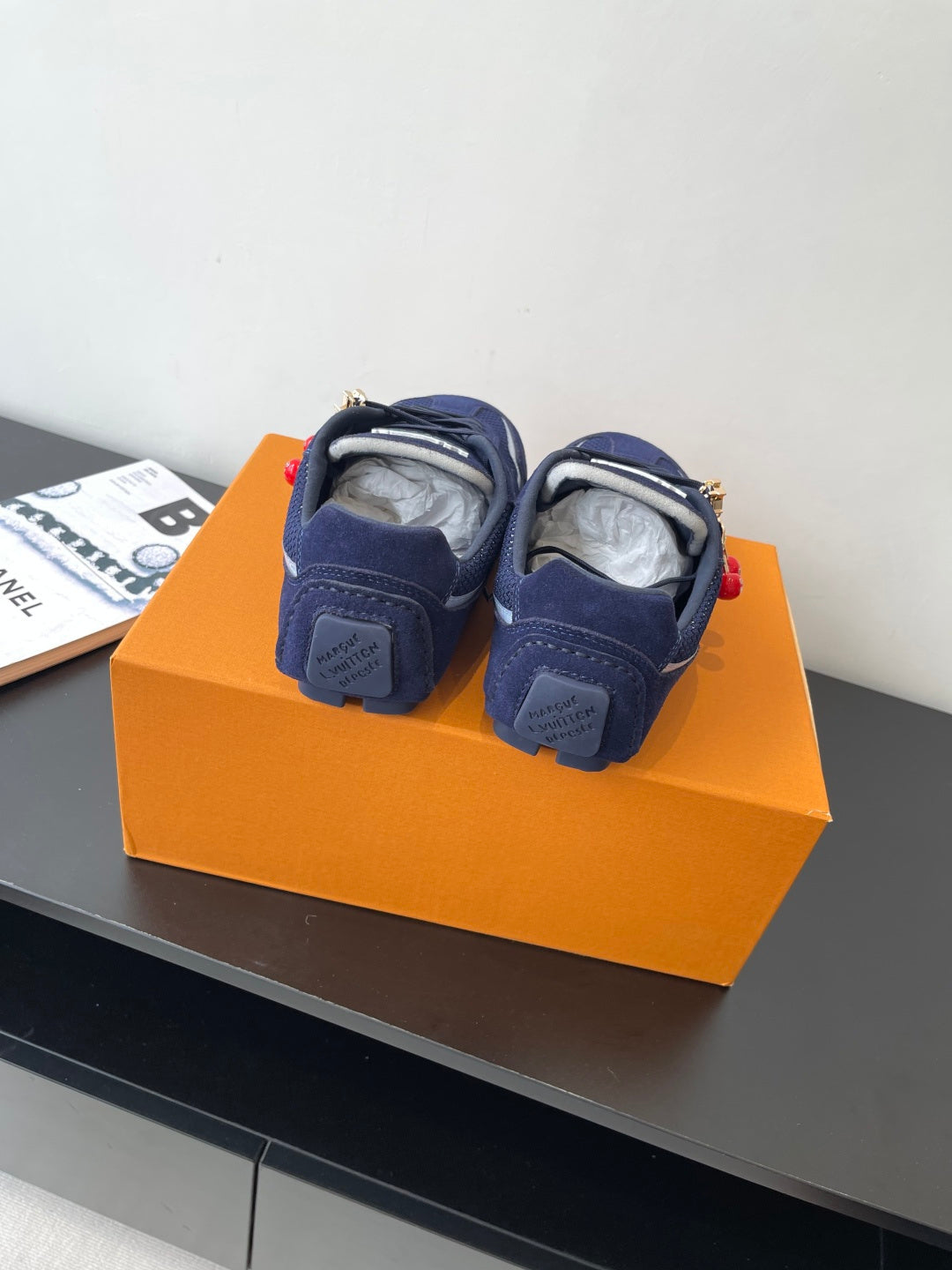 Louis Vuitton ladies navy sneakers, back view with heel tabs and laces, pair on box