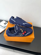 Louis Vuitton ladies navy sneakers, angled top view with lace-up and charm embroidery
