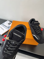 Black Louis Vuitton sneakers, front view with LV logo and red bead charms