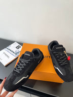 Black Louis Vuitton sneakers, lace-up style with multicolor charm accents
