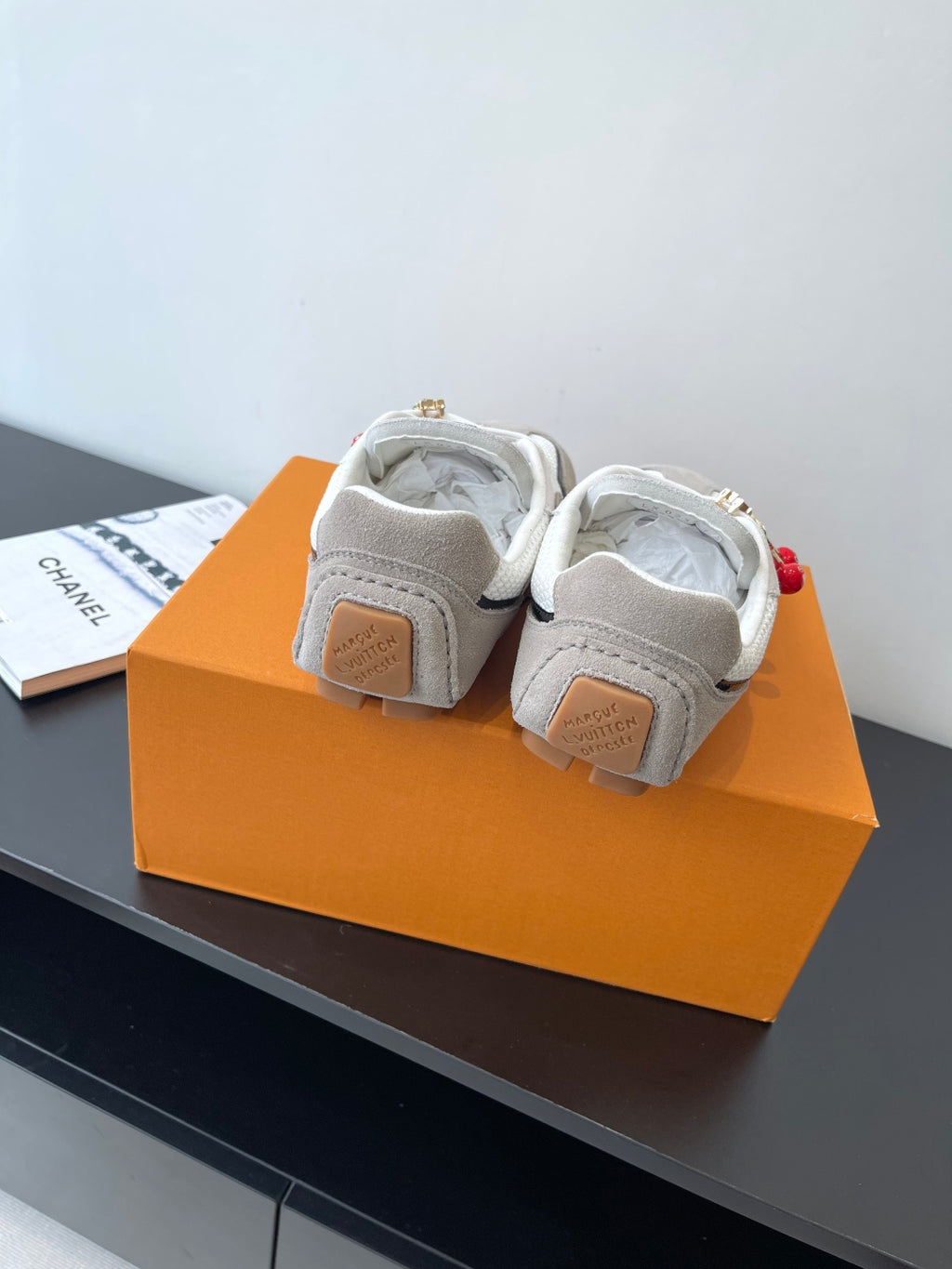 Louis Vuitton low-top sneakers, off-white canvas with gray heel patches and gold studs