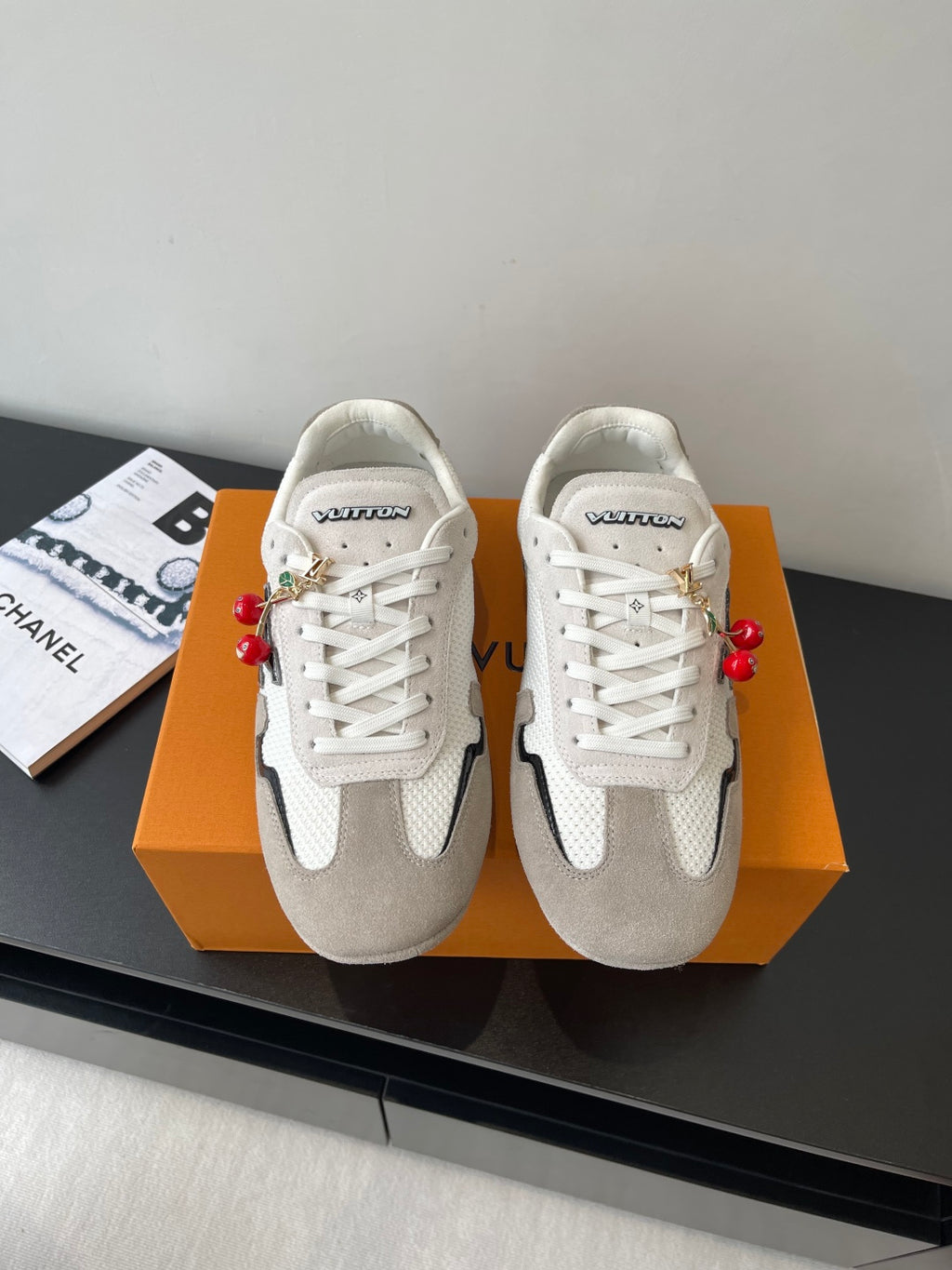 Pair of Louis Vuitton low-top sneakers, white laces, off-white and gray panels