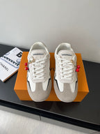 Pair of Louis Vuitton low-top sneakers, white laces, off-white and gray panels