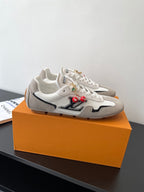Louis Vuitton low-top sneakers, off-white with gray panels and red charm details