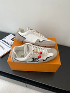 Louis Vuitton low-top sneakers, off-white canvas with gray panels and red lace charms