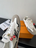Louis Vuitton low-top sneakers, off-white with black side logo and red charms