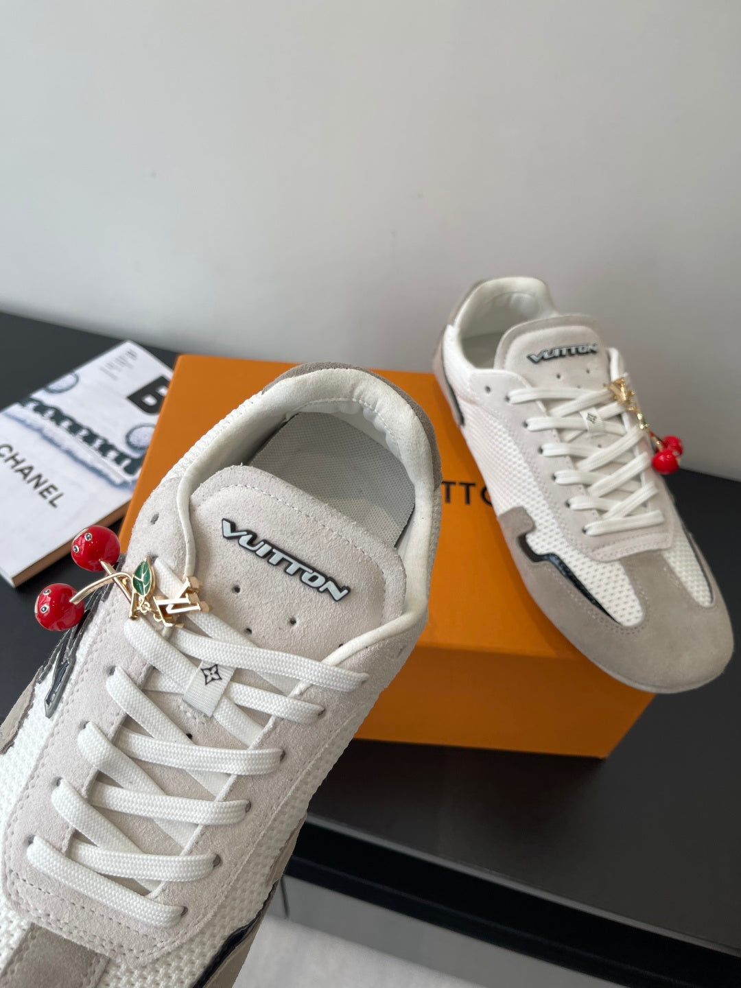 Louis Vuitton low-top sneakers, off-white with gray trim and gold lace hardware