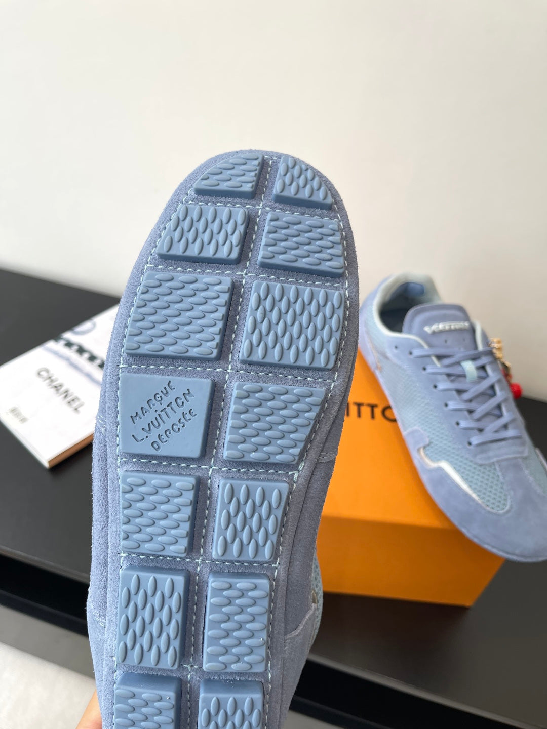 Light-blue sneaker outsole close-up with textured tread and molded square pattern