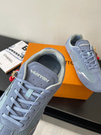 Light-blue lace-up sneaker close-up with perforated tongue and padded collar