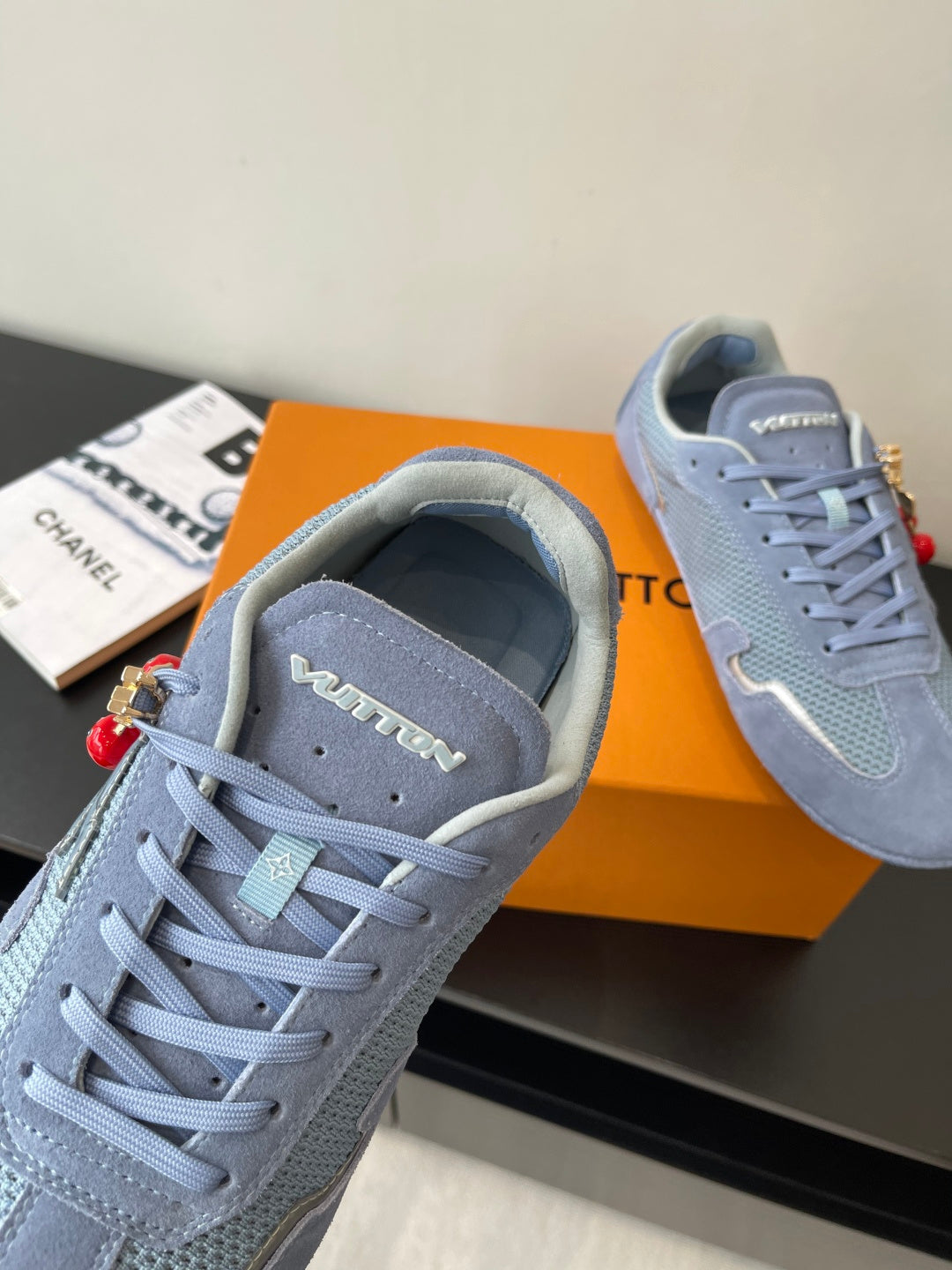 Light-blue lace-up sneaker close-up with perforated tongue and padded collar