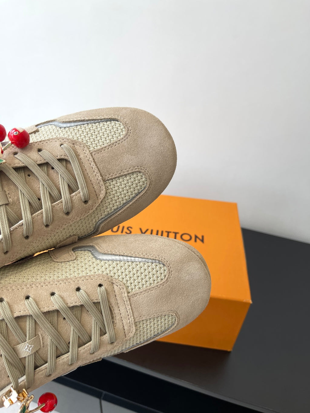 Beige Louis Vuitton ladies sneakers, close-up toe and lace with cherry charm