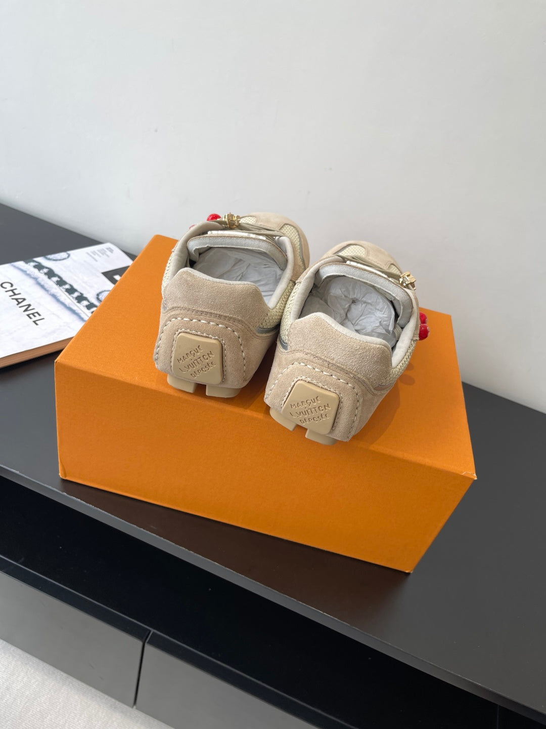 Beige Louis Vuitton ladies sneakers, heel and tongue view with rear logo patch