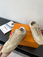 Beige Louis Vuitton ladies lace-up sneakers, angled front view with detailed panels