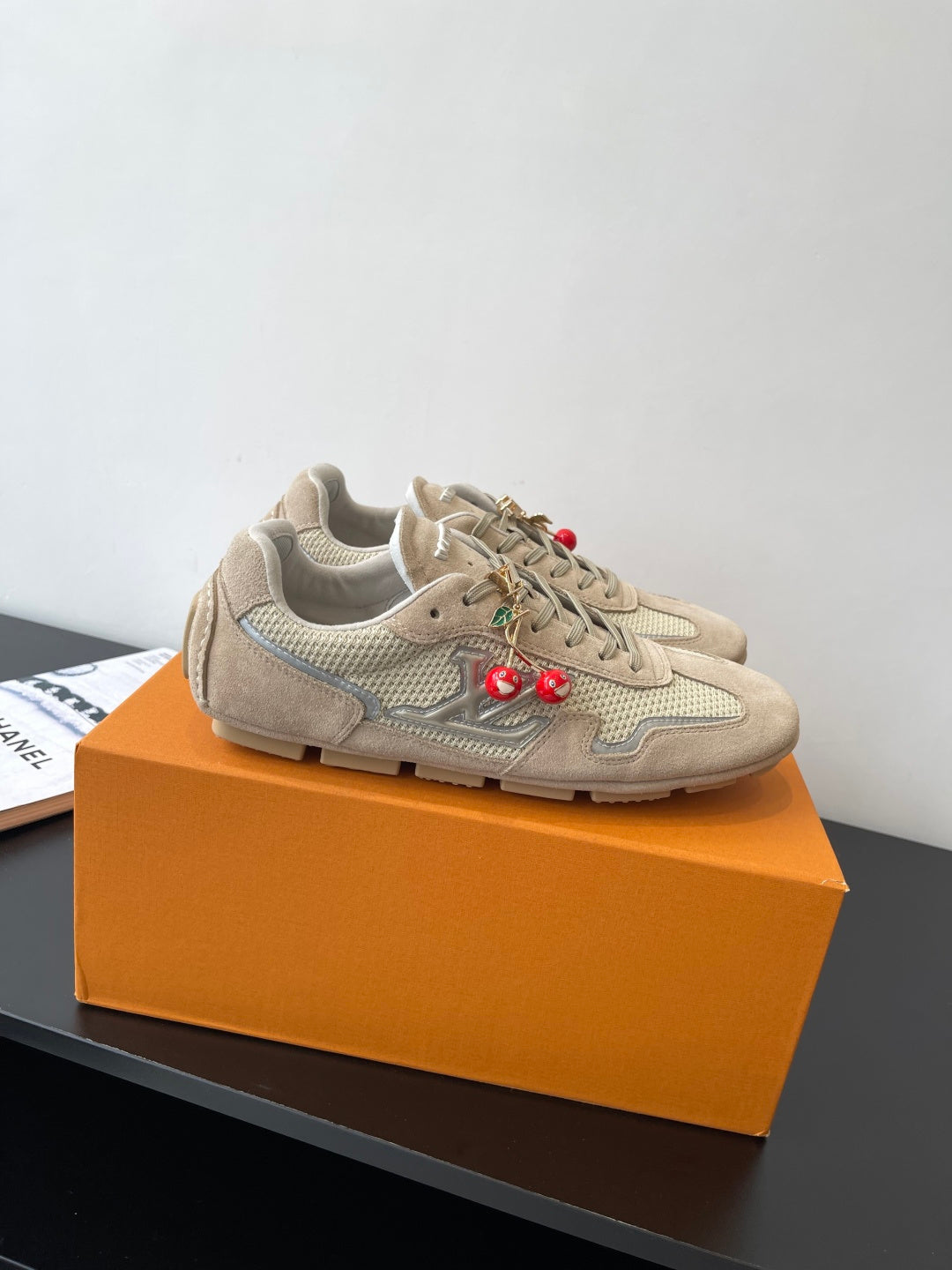 Beige Louis Vuitton ladies lace-up sneakers, side view with cherry charms