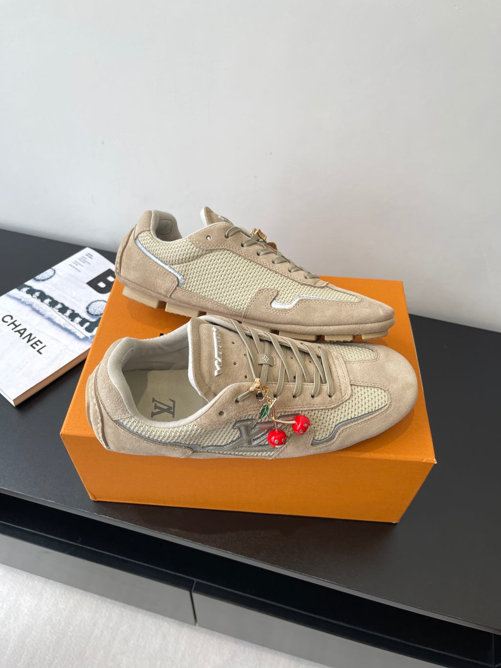 Beige Louis Vuitton ladies lace-up sneakers on display, front and side views