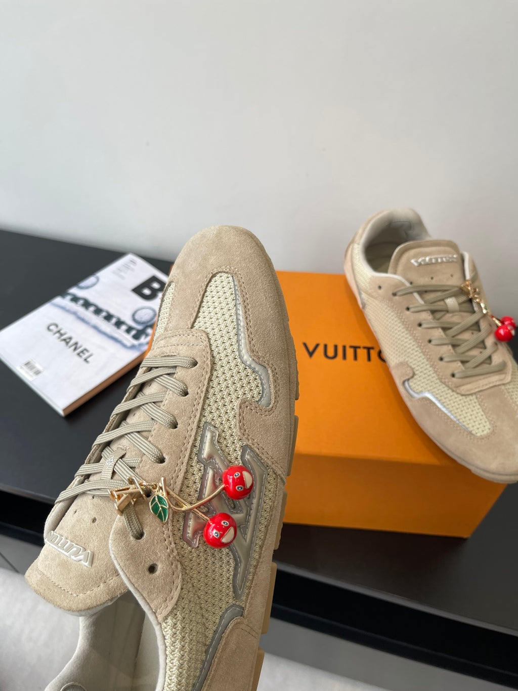 Beige Louis Vuitton ladies sneakers, side view with lace and cherry charm