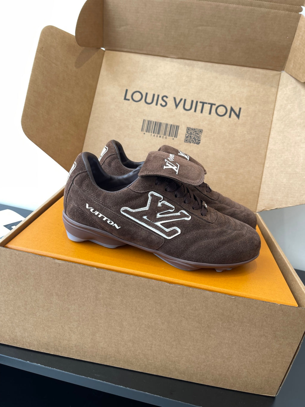 Brown suede lace-up sneakers with bold LV pattern on side