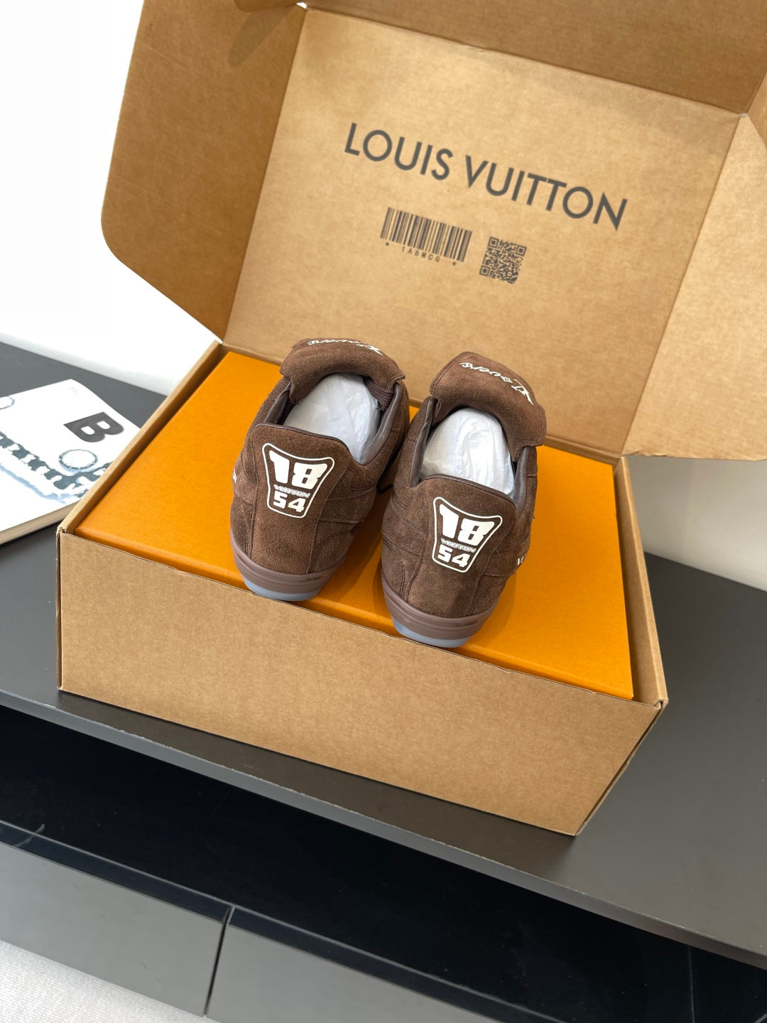 Brown suede sneakers with heel tab and LV logo